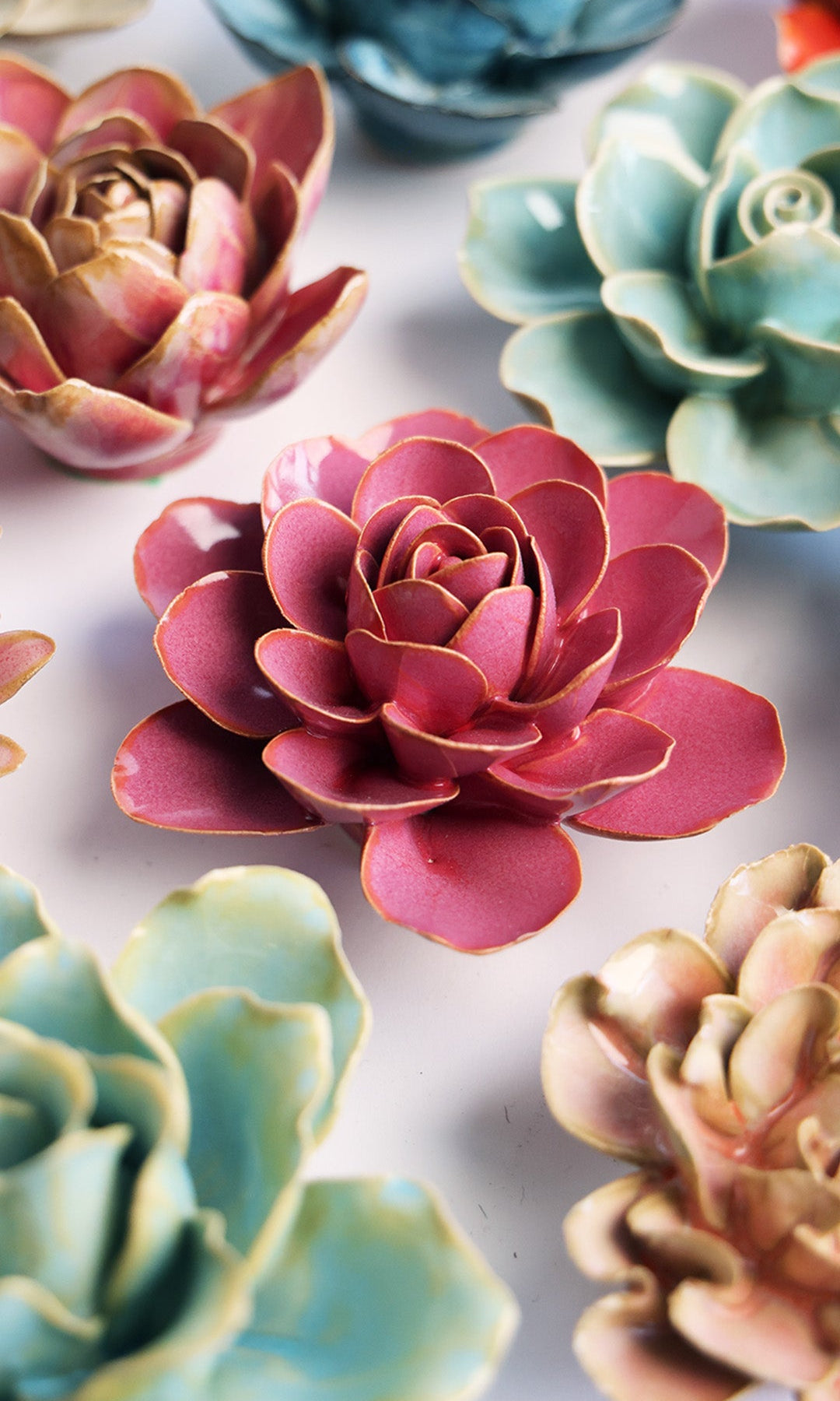 Blush Pink Begonia ceramic wall flower styled on a white table with other flowers — Chive Studio