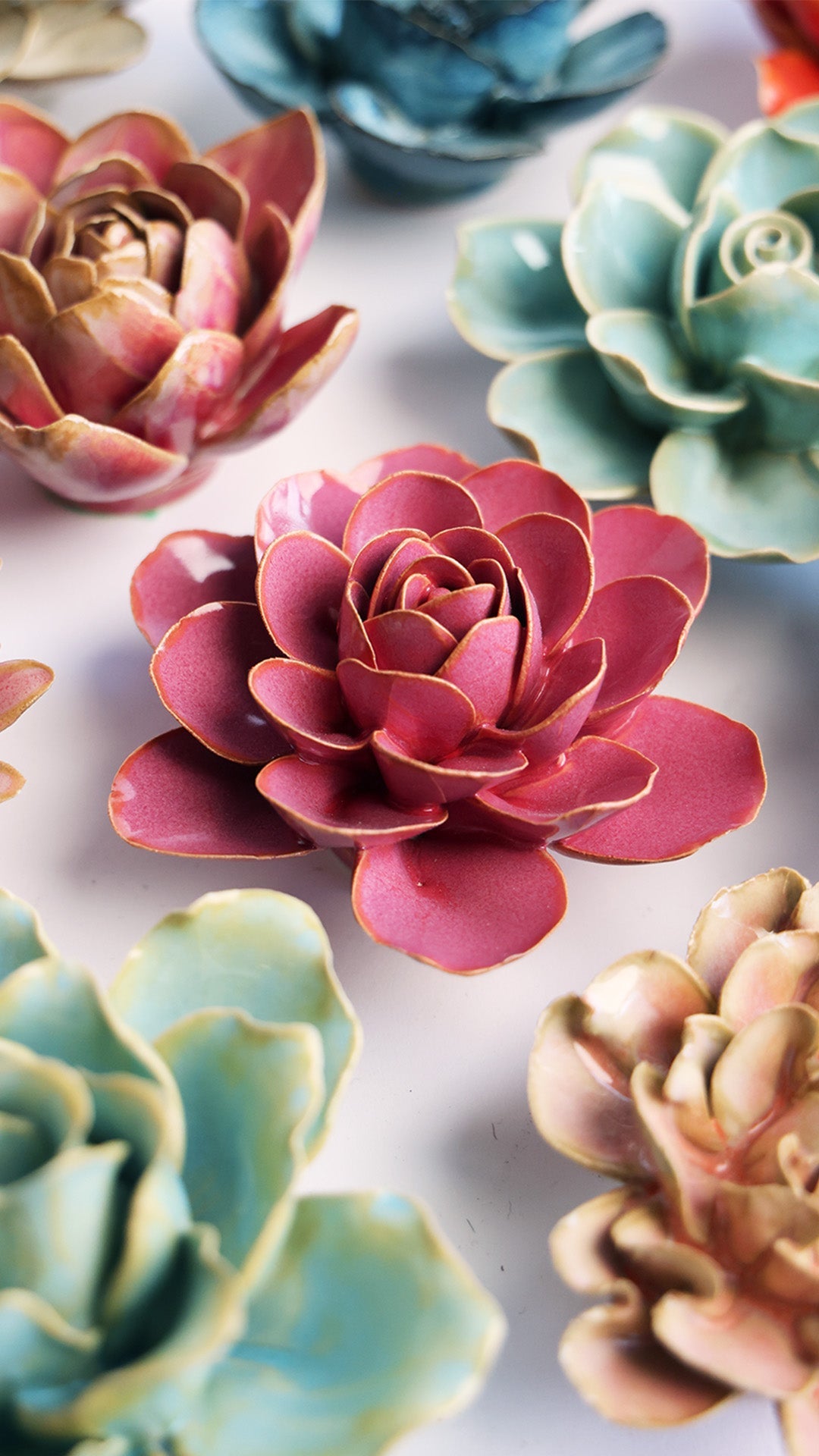 Blush Pink Begonia ceramic wall flower styled on a white table with other flowers — Chive Studio
