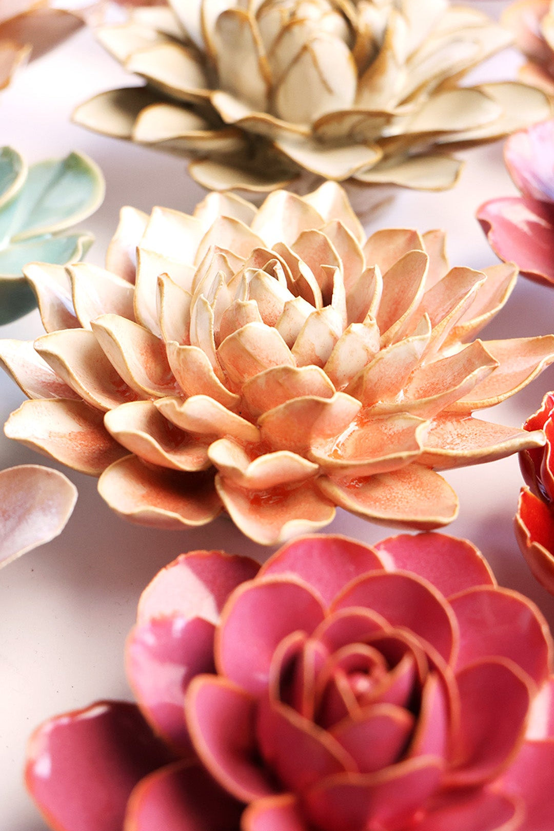Peach Pink Azalea ceramic wall flower styled on a white table with other flowers — Chive Studio