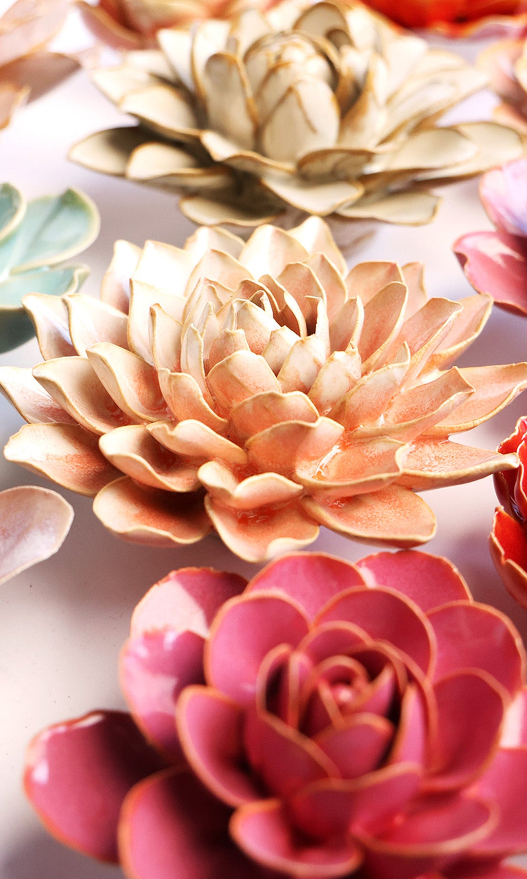 Peach Pink Azalea ceramic wall flower styled on a white table with other flowers — Chive Studio