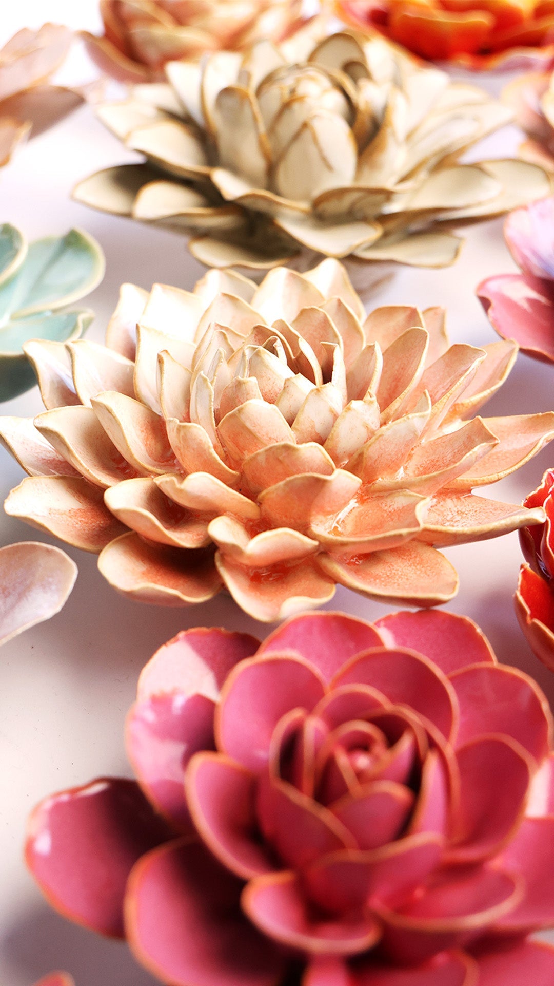 Peach Pink Azalea ceramic wall flower styled on a white table with other flowers — Chive Studio