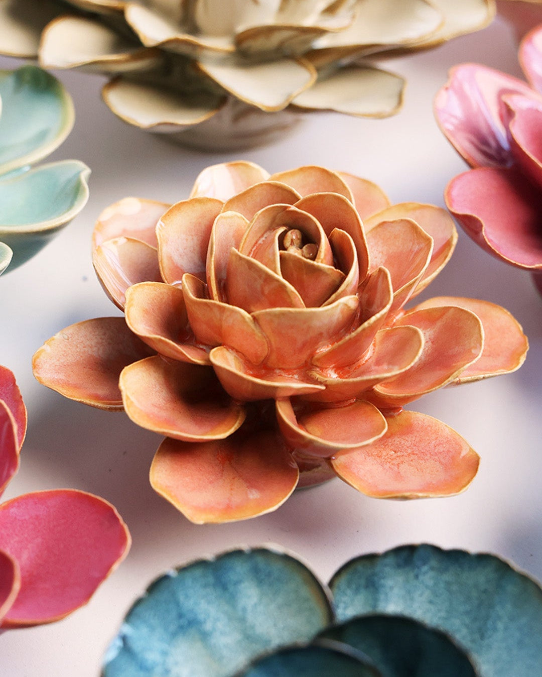 Peach Pink Begonia ceramic wall flower mounted on a wall — Chive Ceramics Studio