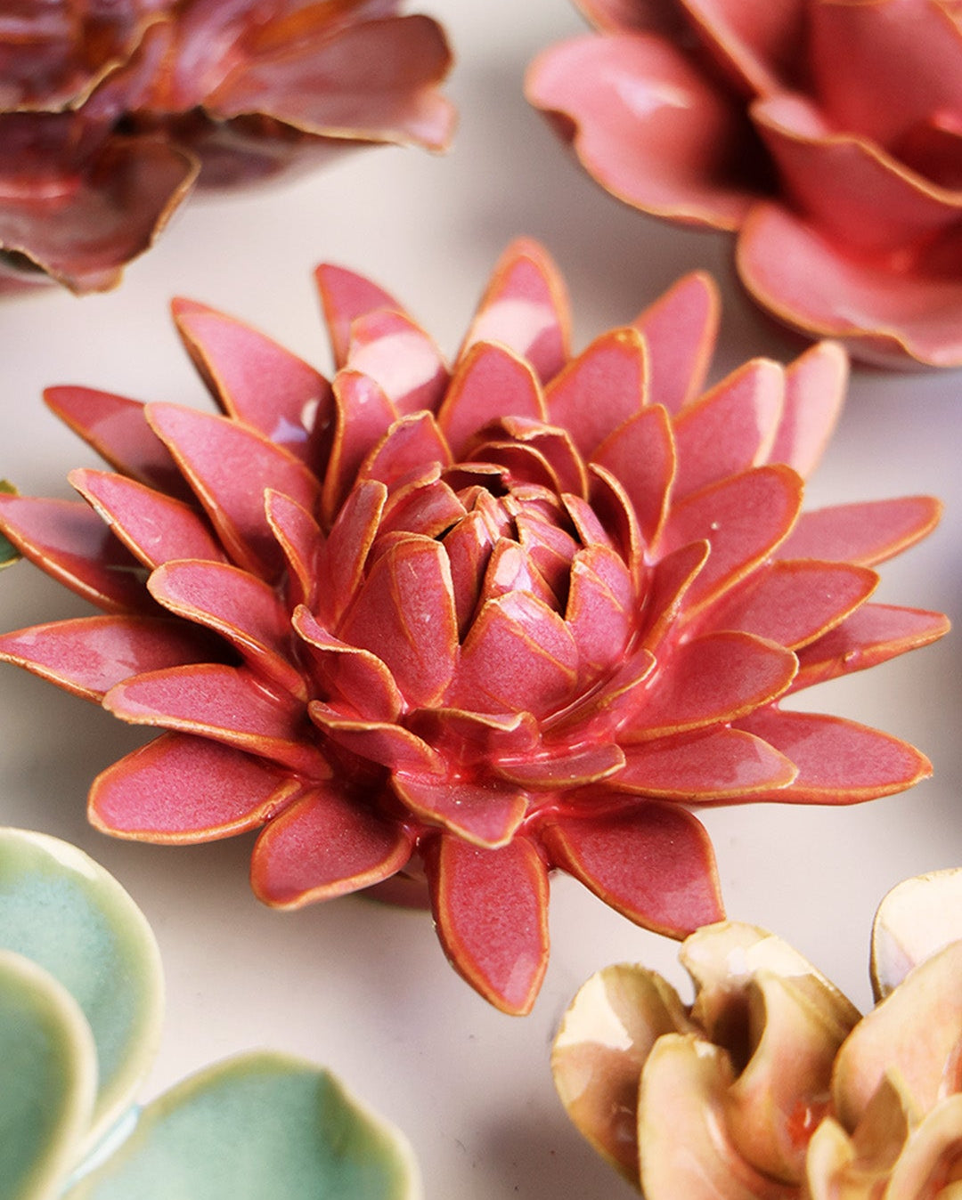 Blush Pink Strawflower ceramic wall flower styled on a white table with other flowers — Chive Studio