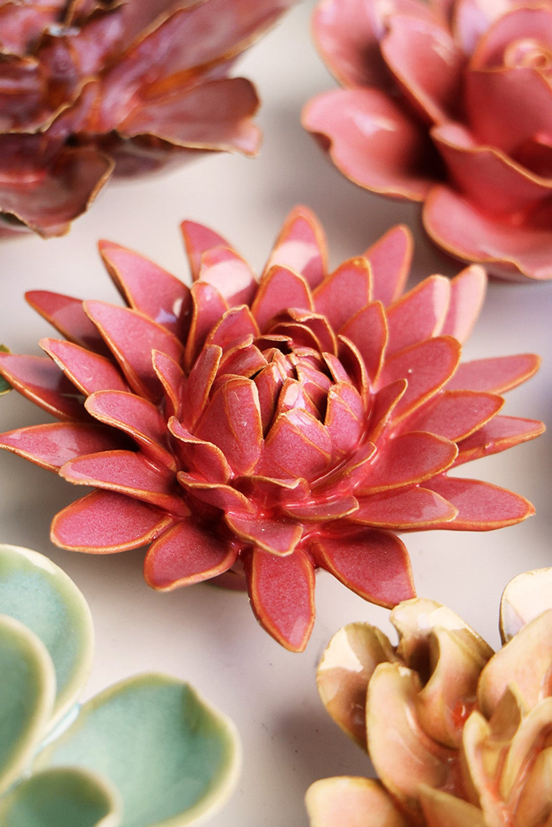Blush Pink Strawflower ceramic wall flower styled on a white table with other flowers — Chive Studio