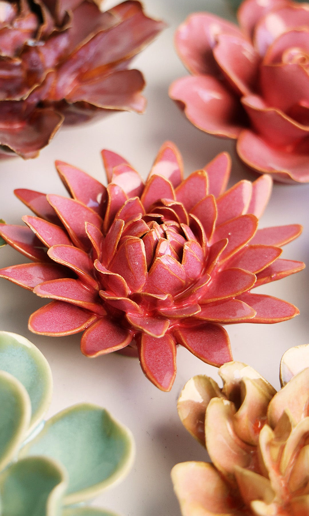 Blush Pink Strawflower ceramic wall flower styled on a white table with other flowers — Chive Studio