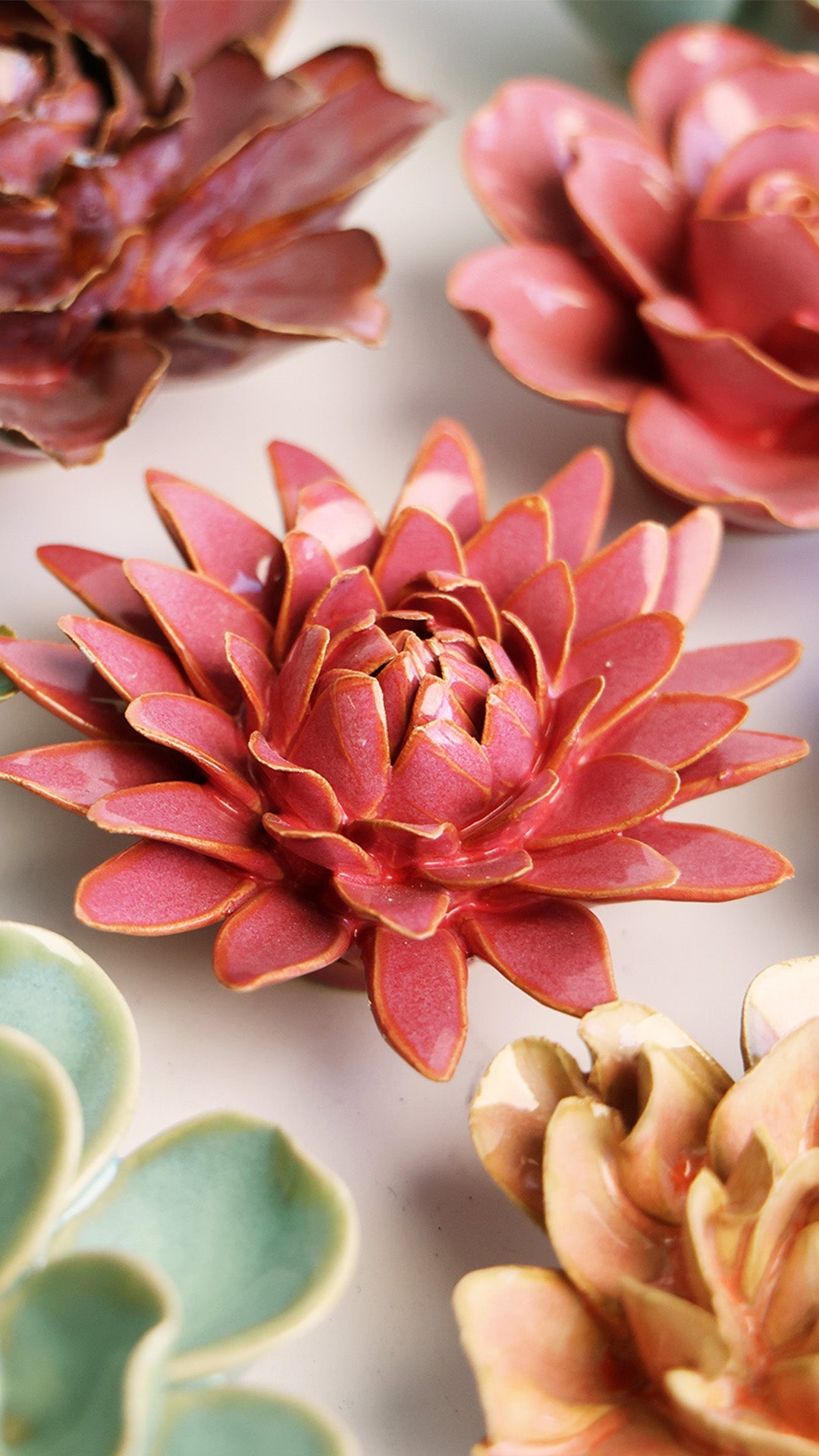 Blush Pink Strawflower ceramic wall flower styled on a white table with other flowers — Chive Studio