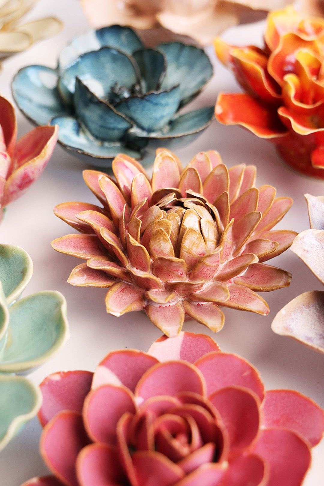 Rose Quartz Strawflower ceramic wall flower styled on a white table with other flowers — Chive Studio