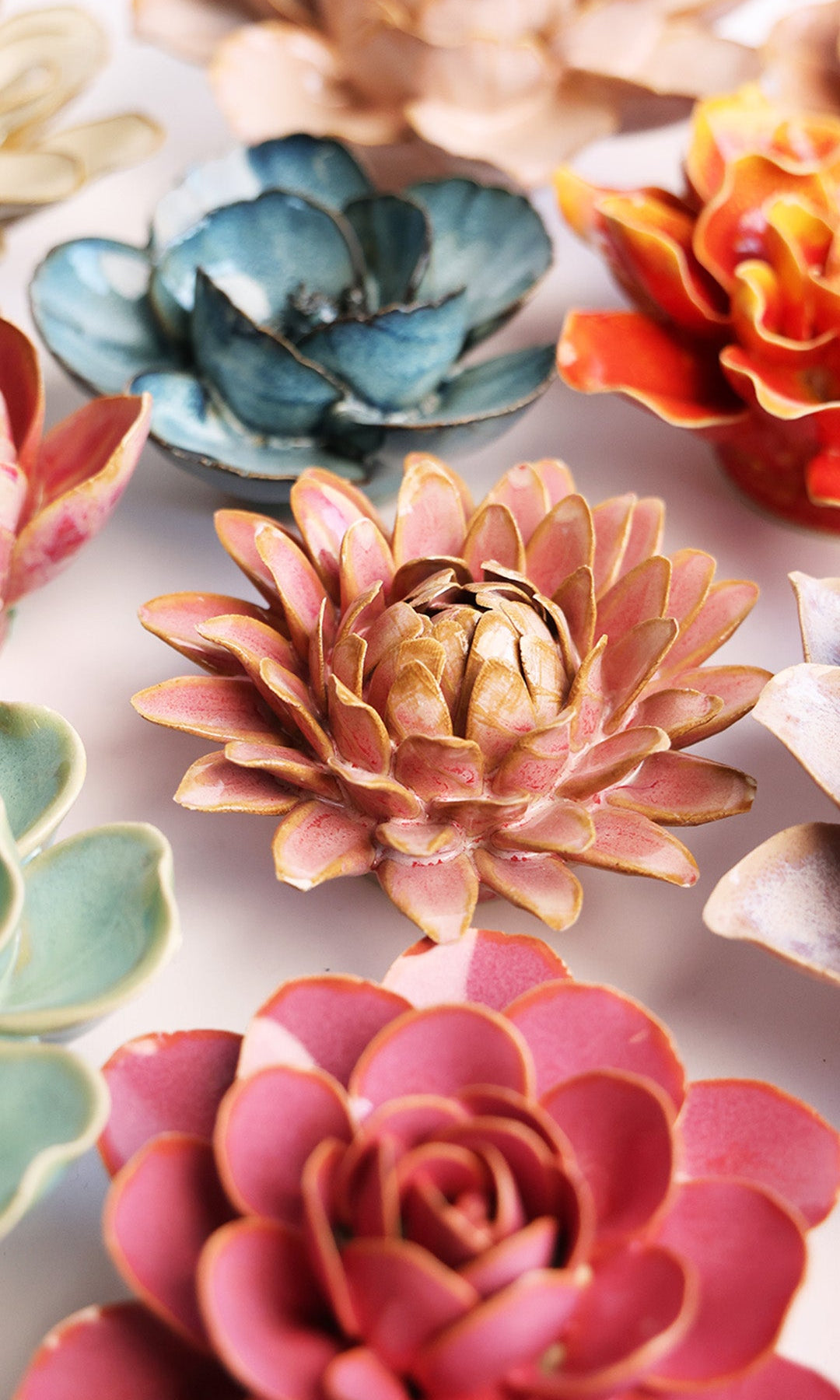 Rose Quartz Strawflower ceramic wall flower styled on a white table with other flowers — Chive Studio