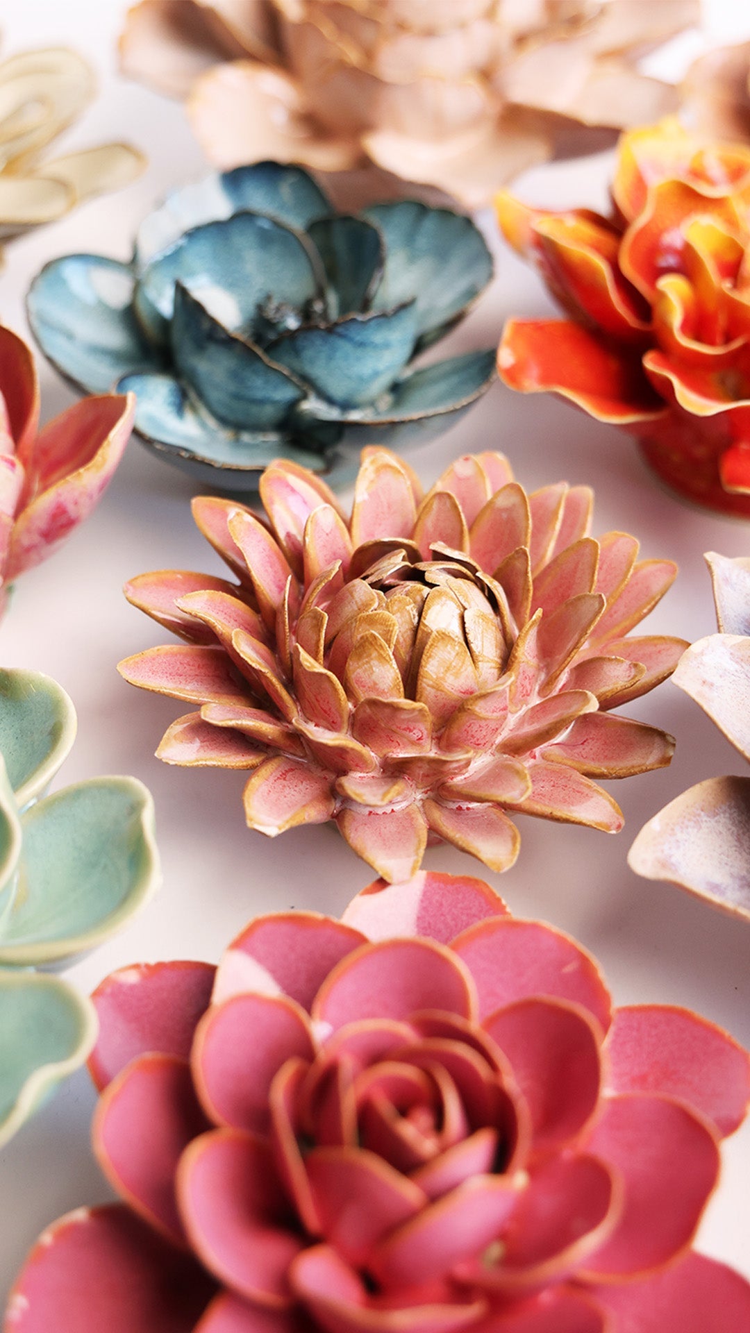 Rose Quartz Strawflower ceramic wall flower styled on a white table with other flowers — Chive Studio