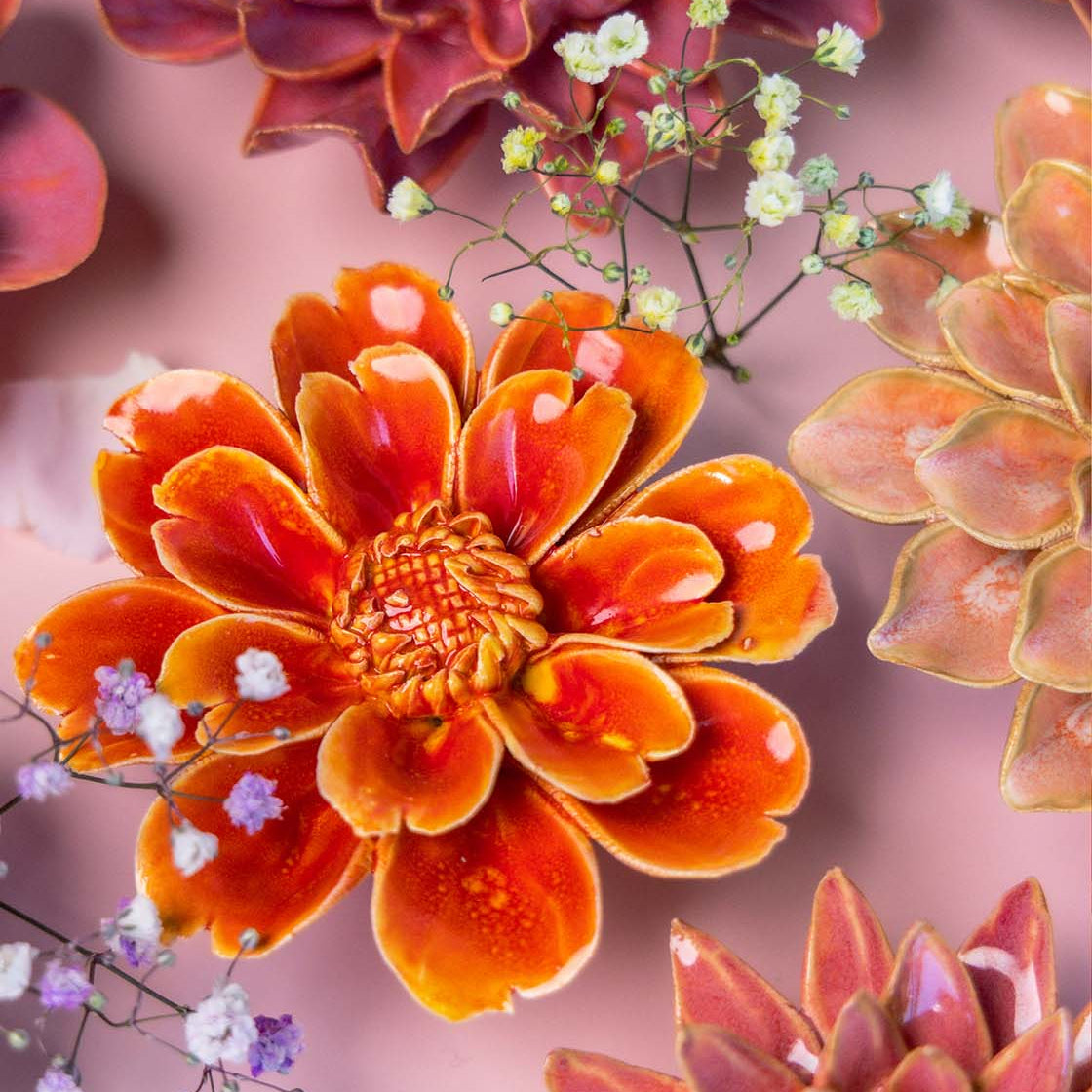 Chive France orange red daisy ceramic flower styled with other pink tone France collection ceramic flowers.