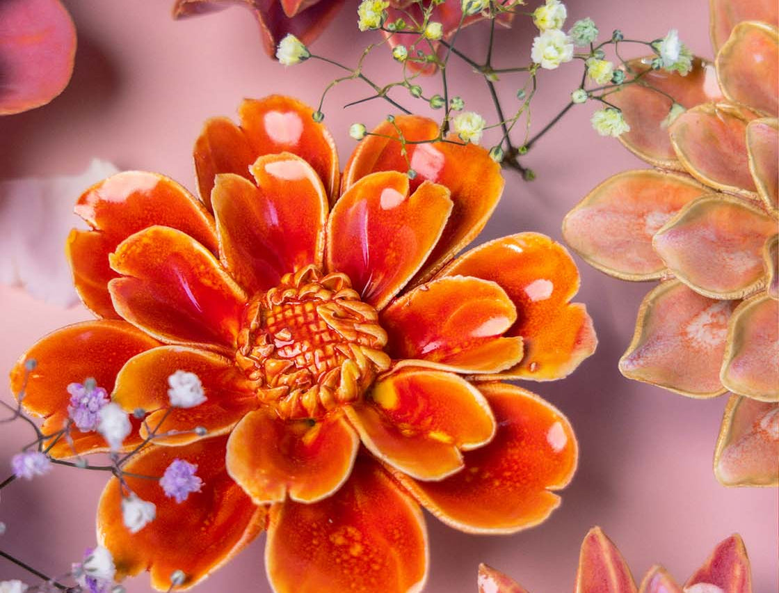 Chive France orange red daisy ceramic flower styled with other pink tone France collection ceramic flowers.