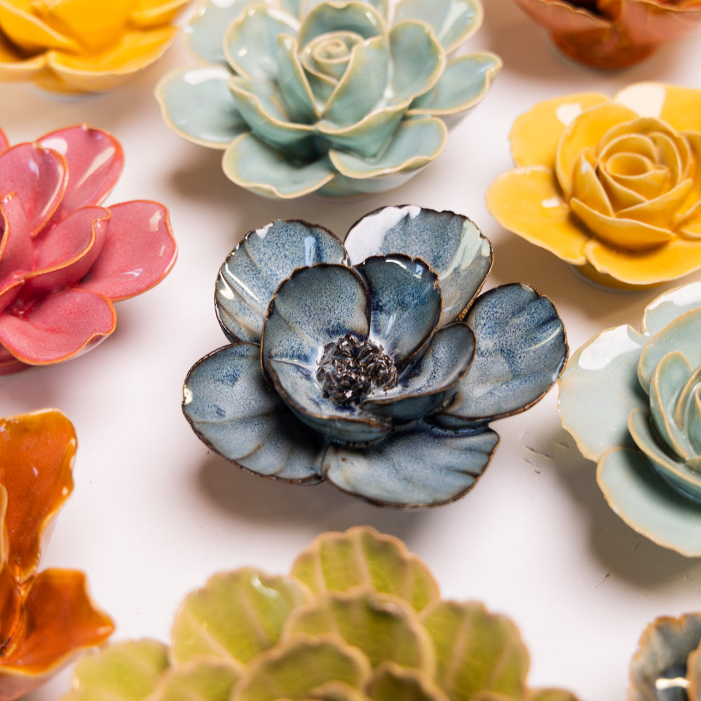 Chive Navy poppy ceramic flower styled with other yellow, green, and pink collection ceramic flowers.
