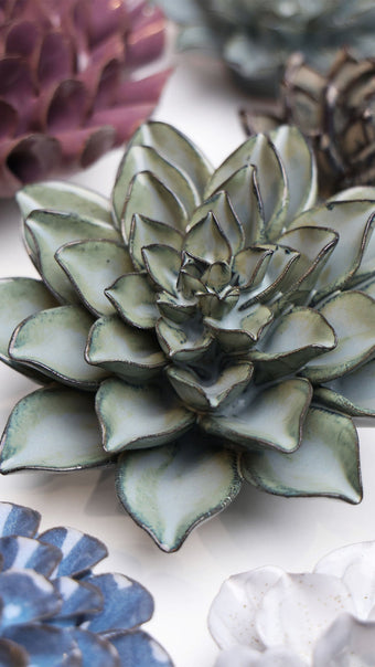 Grey Goyet Azalea ceramic wall flower styled on a white table with other flowers — Chive Studio