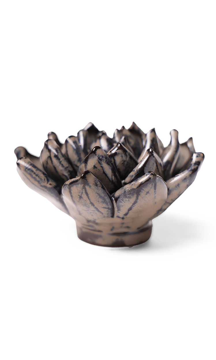 A small ceramic flower-shaped bowl with a textured, metallic bronze finish and dark glaze details, set against a plain white background.