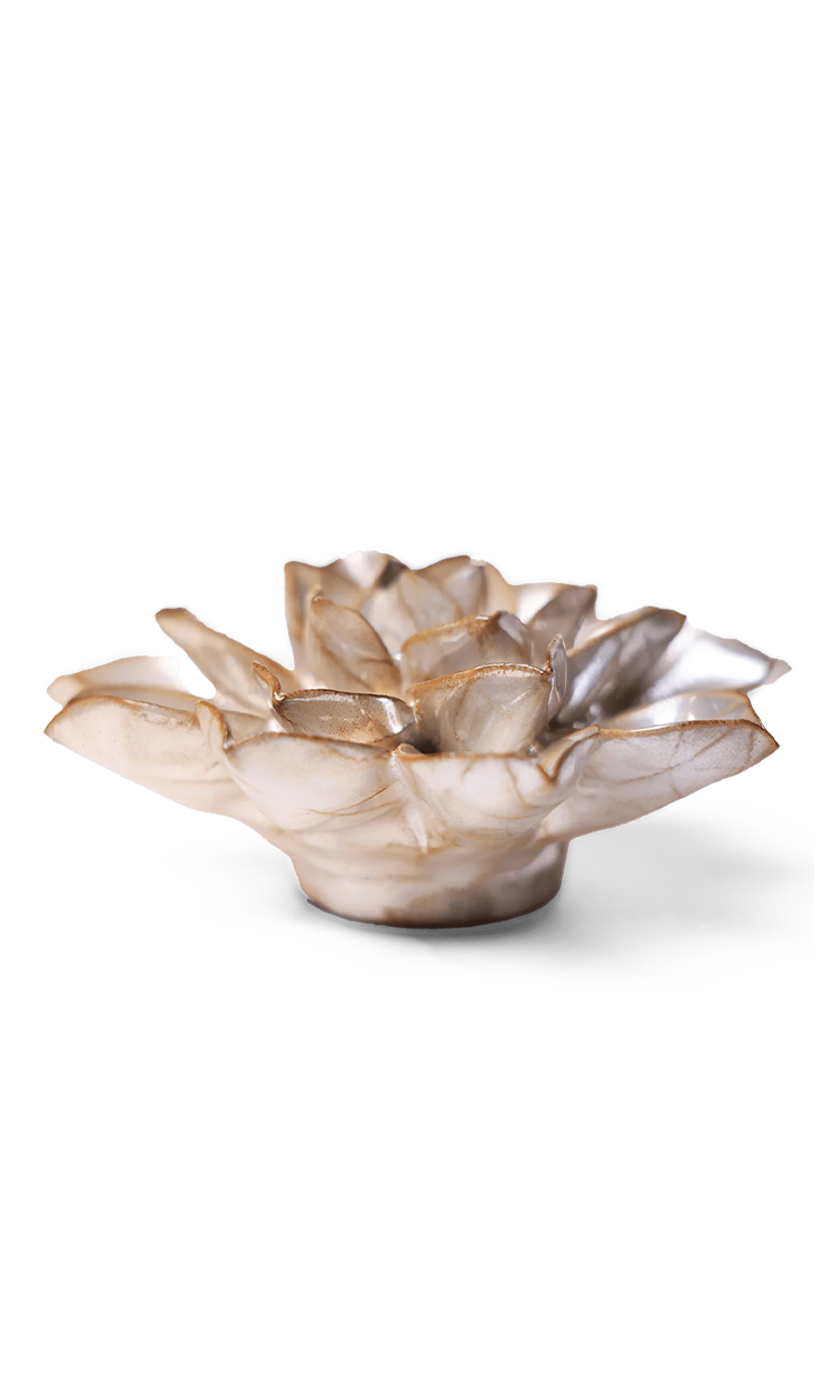 A sculptural lotus-shaped dish or candle holder made from natural mother-of-pearl shell, featuring iridescent beige and cream tones with subtle gold-brown highlights, set against a plain white background.