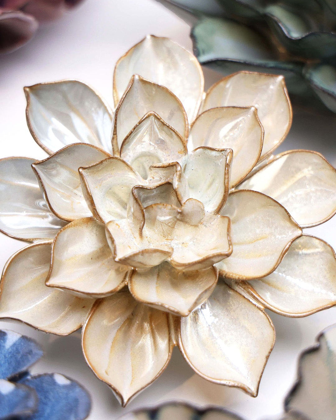 Metallic Frikartii Aster ceramic wall flower styled on a white table with other flowers — Chive Studio