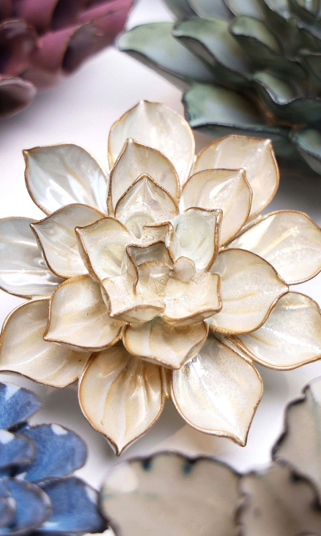 Metallic Frikartii Aster ceramic wall flower styled on a white table with other flowers — Chive Studio