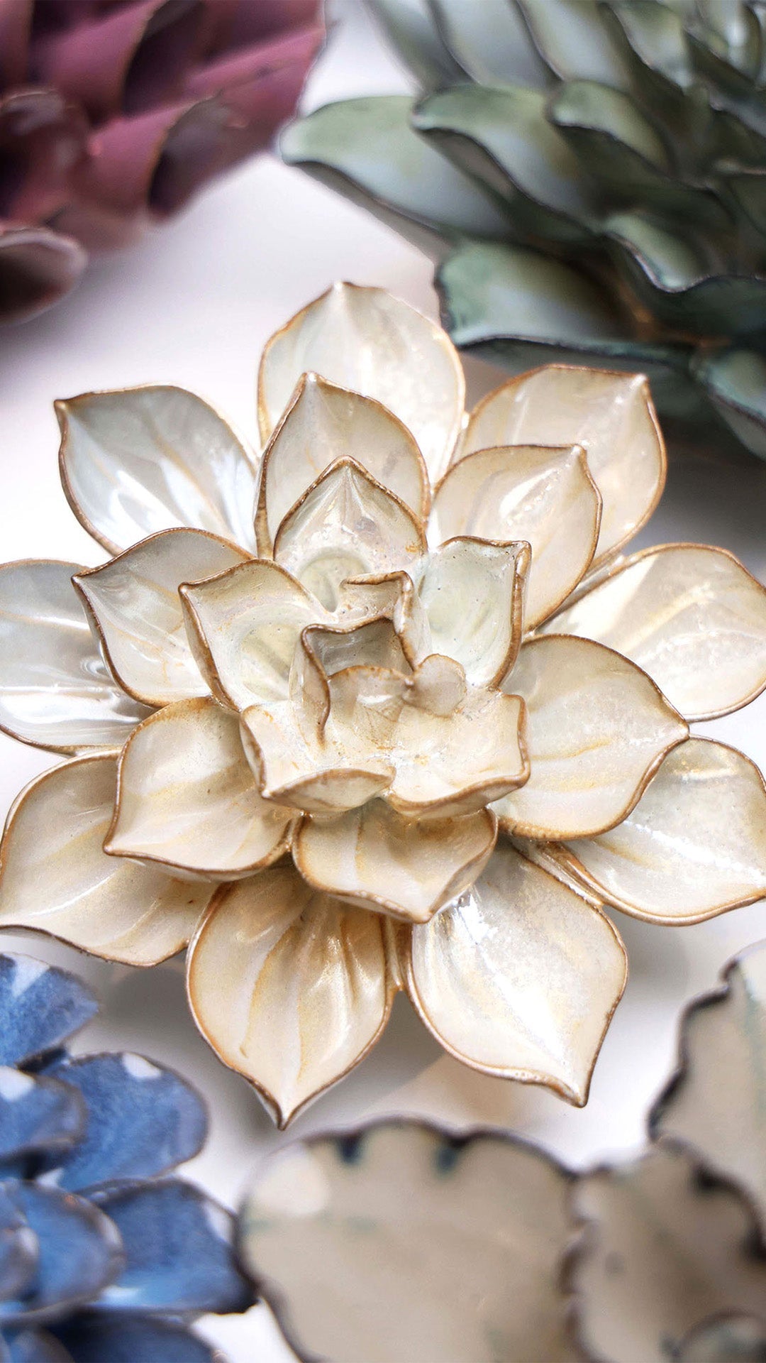 Metallic Frikartii Aster ceramic wall flower styled on a white table with other flowers — Chive Studio