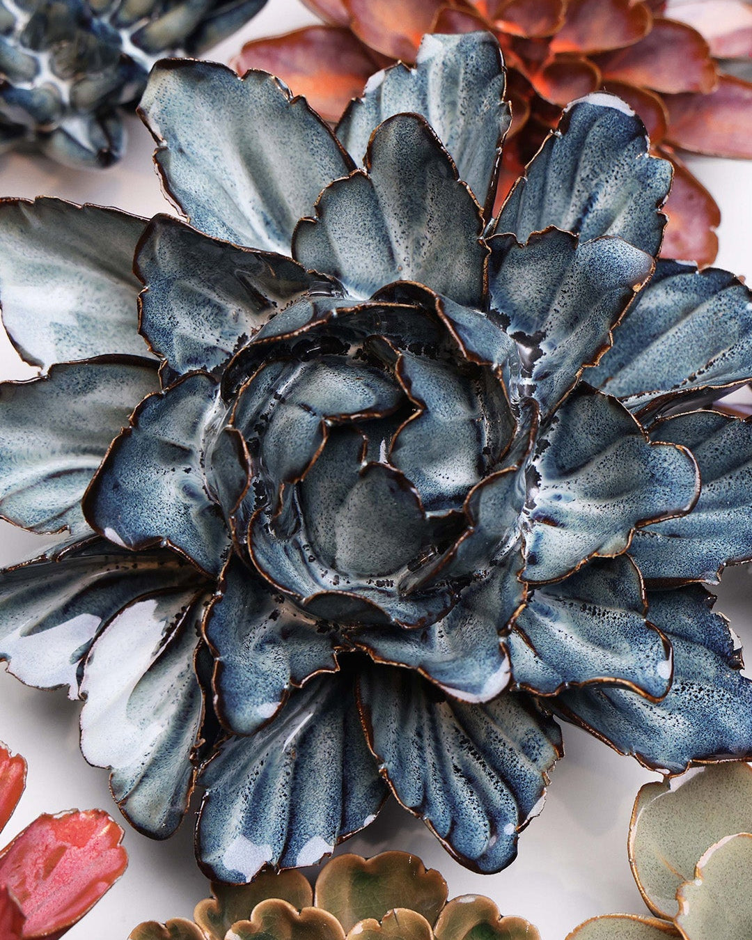 Navy Blue Sorbet Peony ceramic wall flower styled on a white table with other flowers — Chive Studio