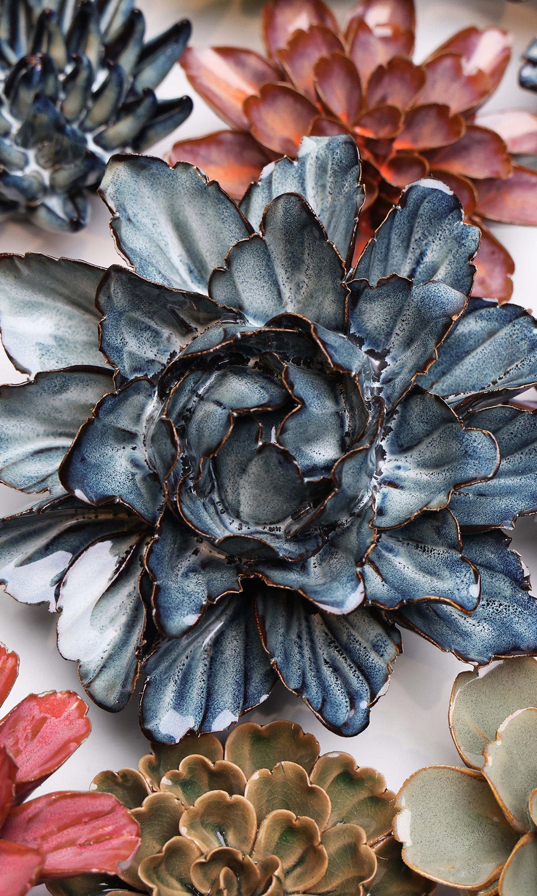 Navy Blue Sorbet Peony ceramic wall flower styled on a white table with other flowers — Chive Studio