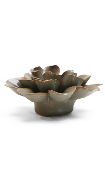 A ceramic flower-shaped bowl with a textured, petal-like surface and a rustic brown glaze, photographed on a clean white background.