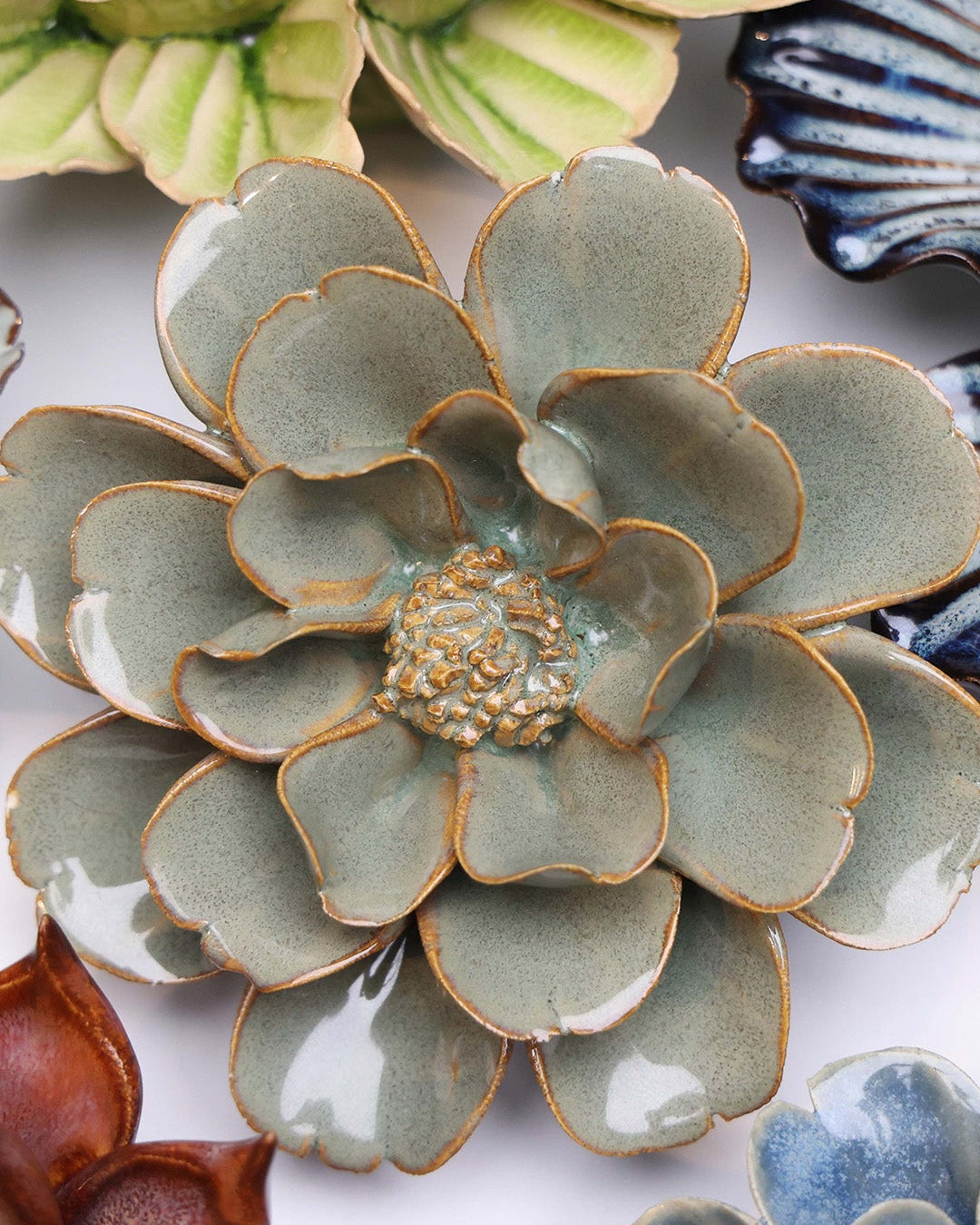 Grey Oxeye Daisy ceramic wall flower styled on a white table with other flowers — Chive Studio