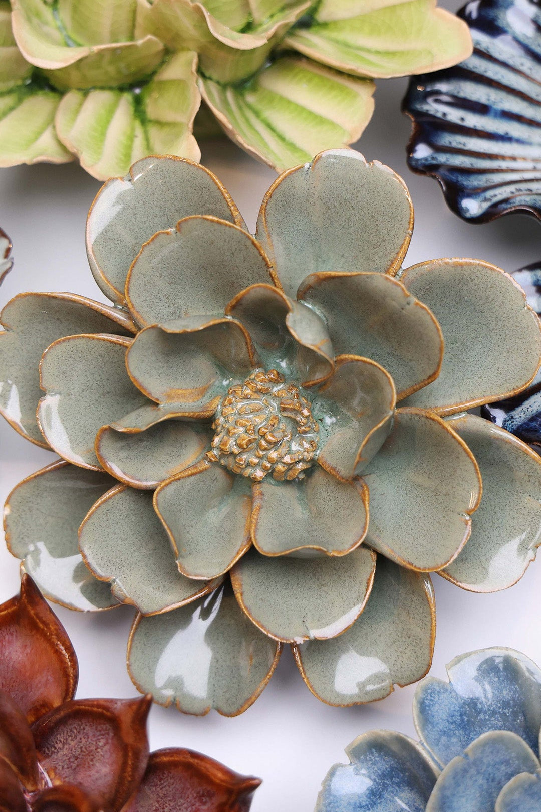 Grey Oxeye Daisy ceramic wall flower styled on a white table with other flowers — Chive Studio