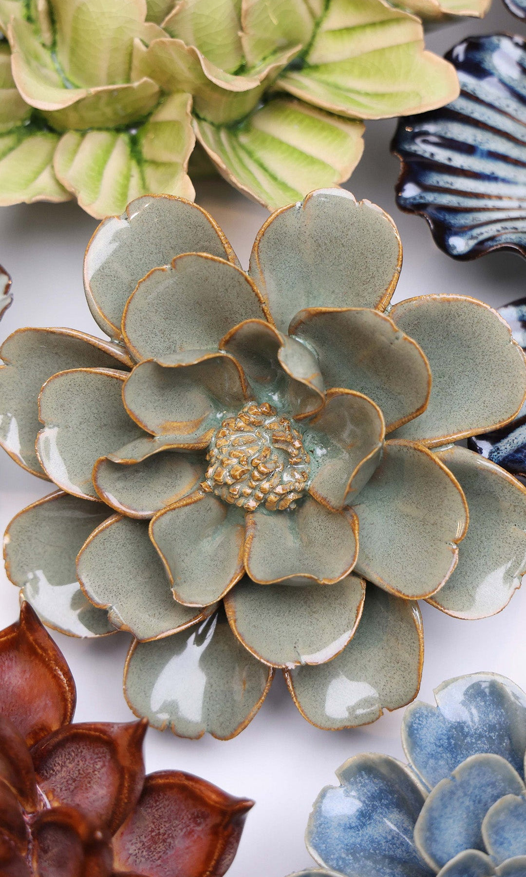 Grey Oxeye Daisy ceramic wall flower styled on a white table with other flowers — Chive Studio