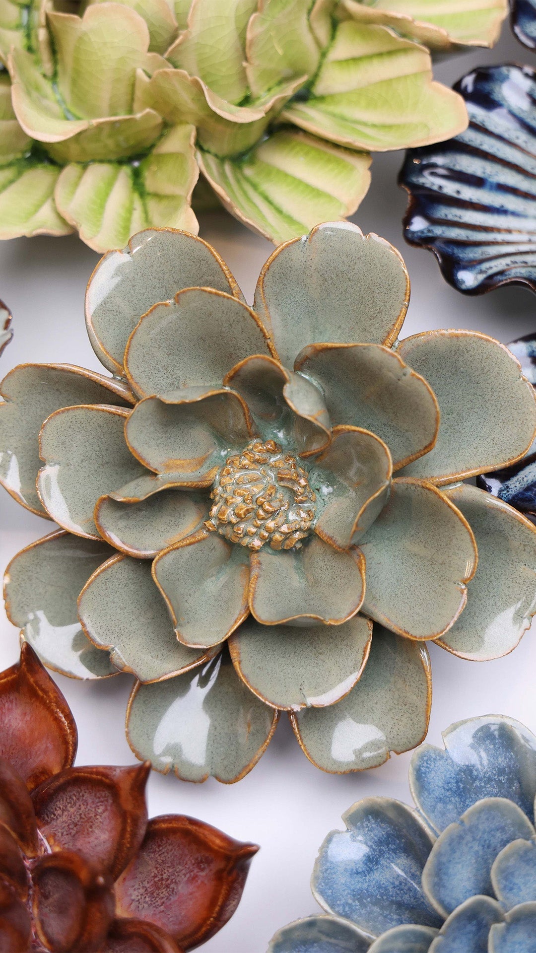 Grey Oxeye Daisy ceramic wall flower styled on a white table with other flowers — Chive Studio