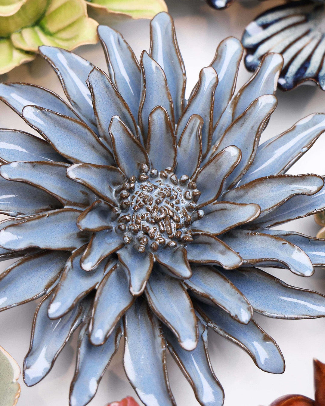 Blue Grey Gerbera Daisy ceramic wall flower styled on a white table with other flowers — Chive Studio