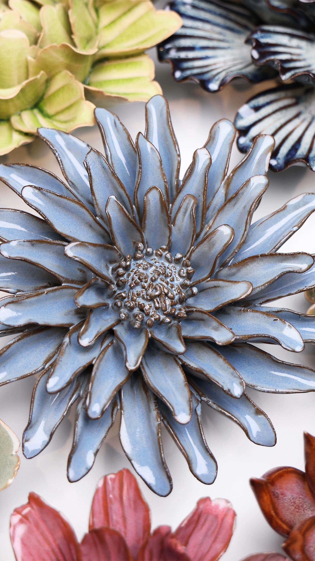 Blue Grey Gerbera Daisy ceramic wall flower styled on a white table with other flowers — Chive Studio