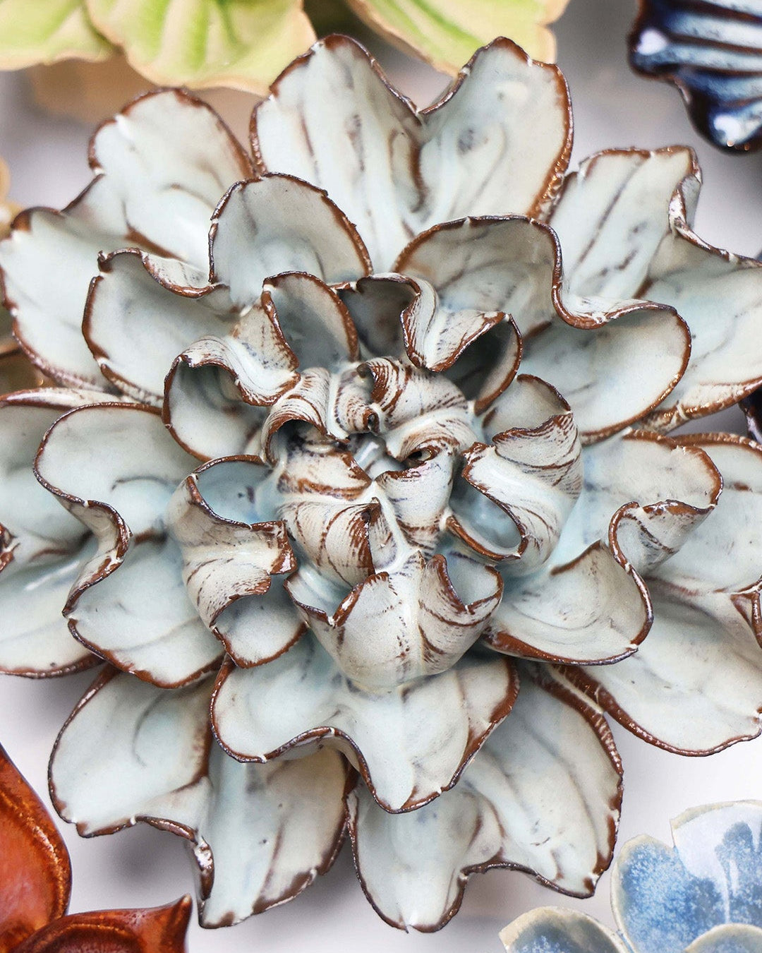 Chocolate Mint Lisianthus ceramic wall flower styled on a white table with other flowers — Chive Studio