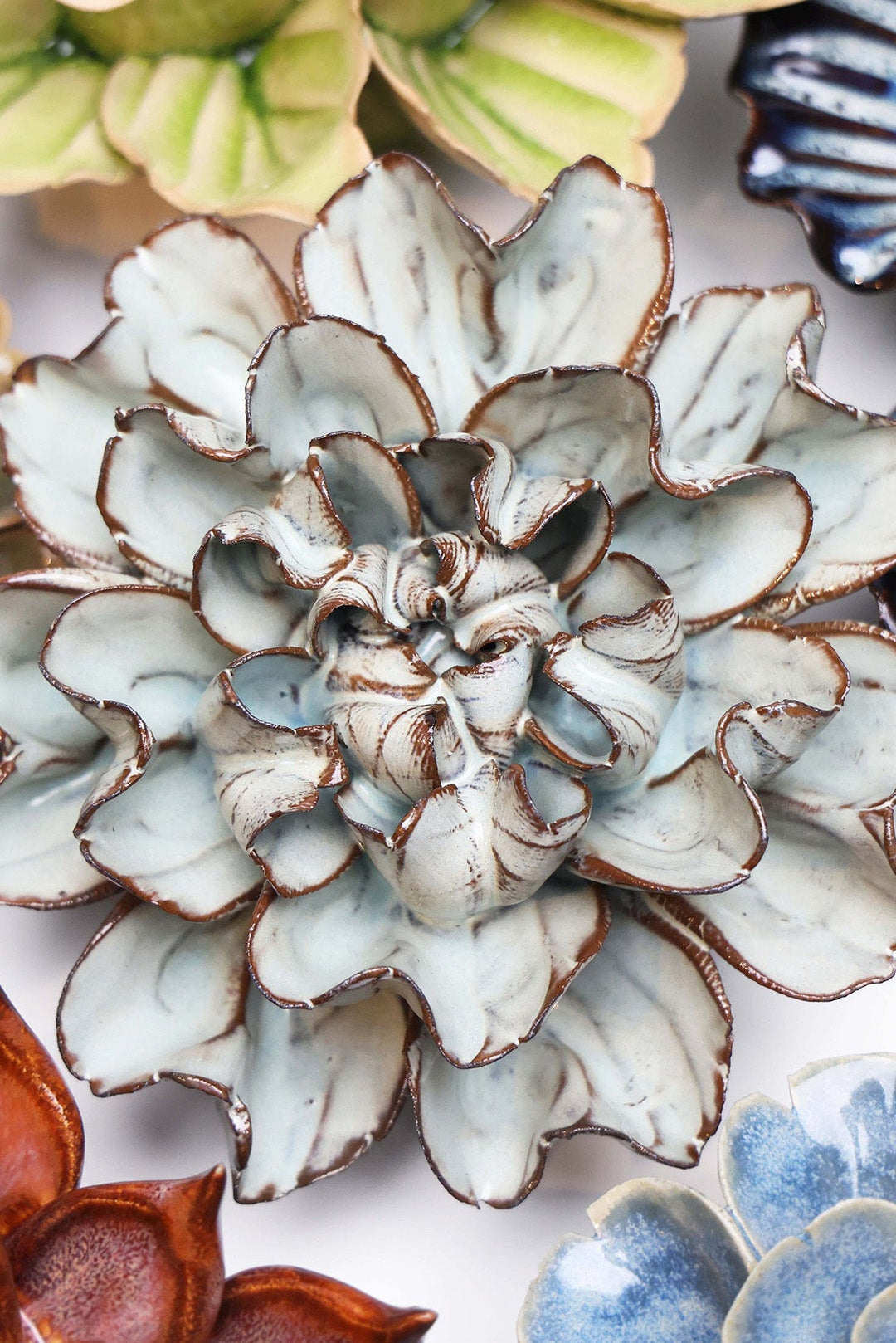 Chocolate Mint Lisianthus ceramic wall flower styled on a white table with other flowers — Chive Studio