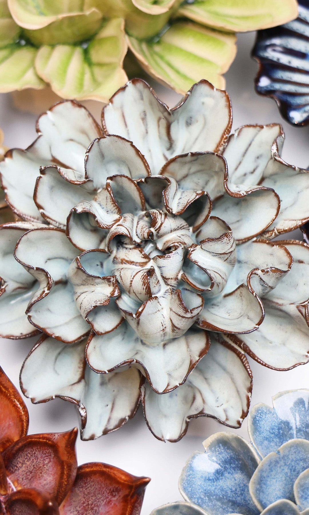 Chocolate Mint Lisianthus ceramic wall flower styled on a white table with other flowers — Chive Studio