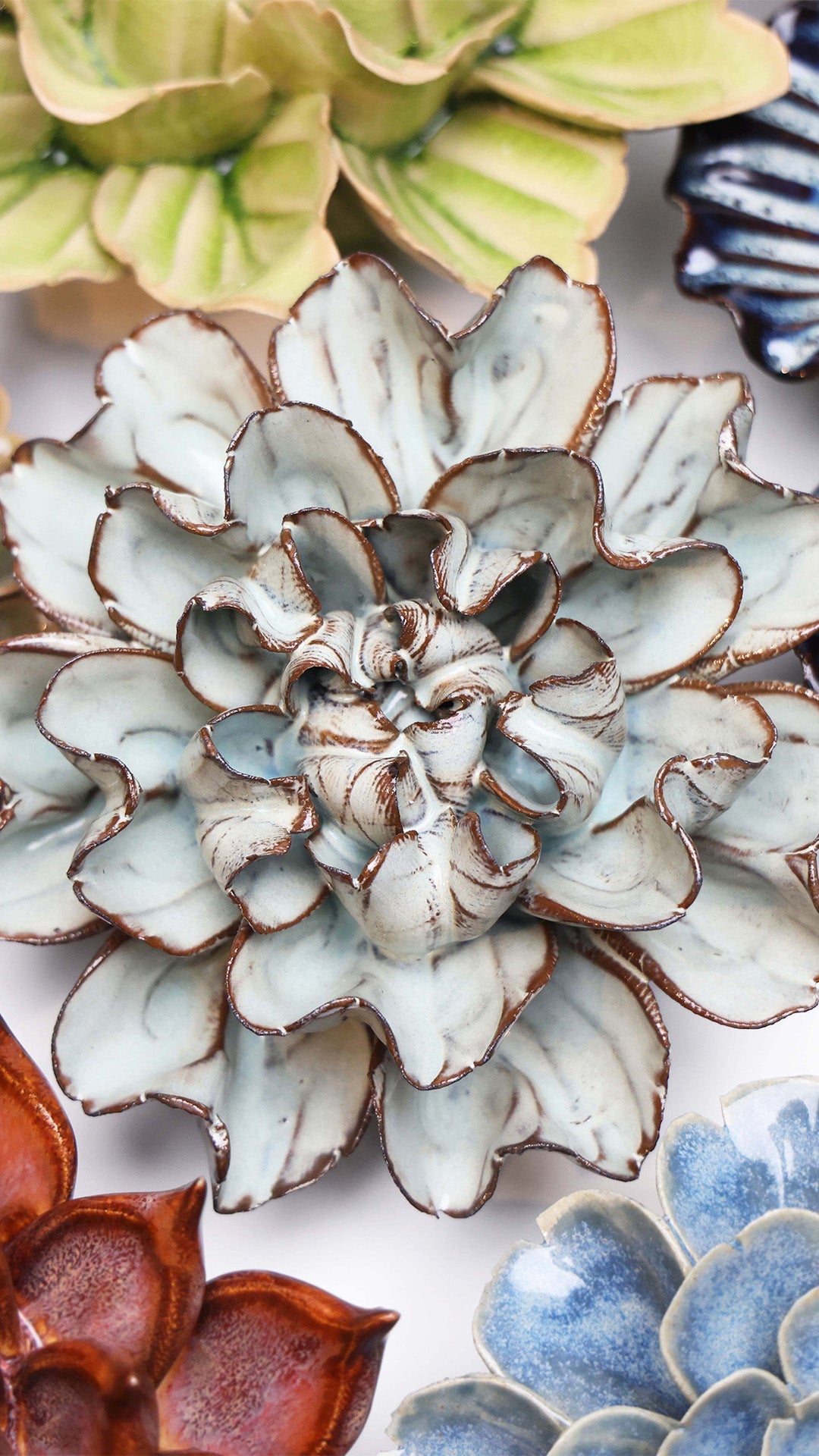 Chocolate Mint Lisianthus ceramic wall flower styled on a white table with other flowers — Chive Studio