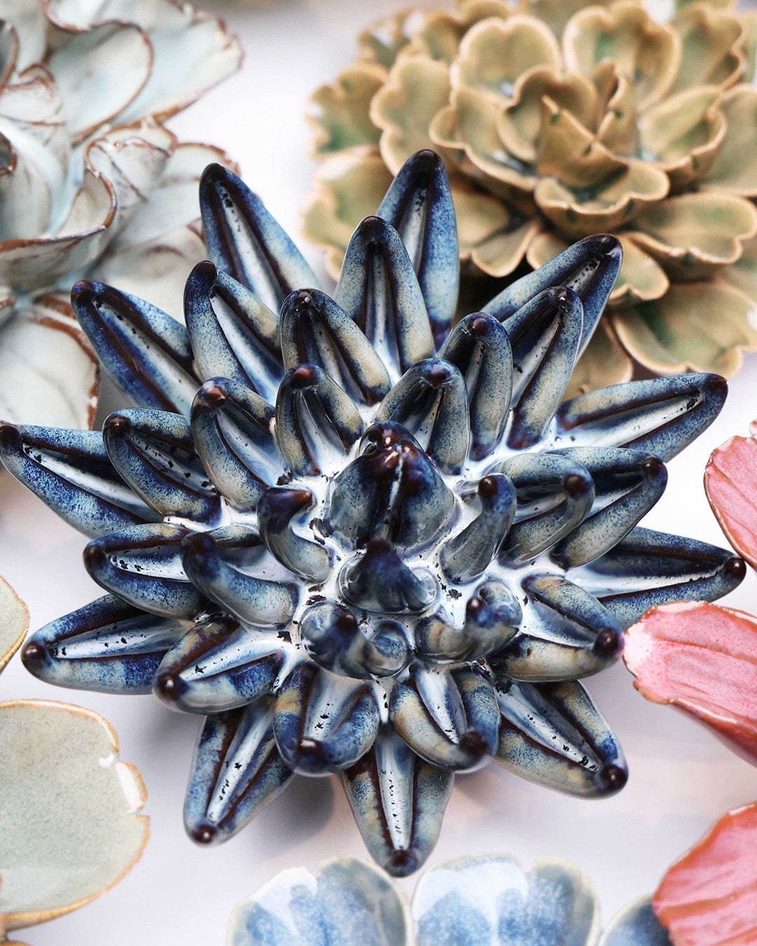 Navy Blue Succulent ceramic wall flower styled on a white table with other flowers — Chive Studio
