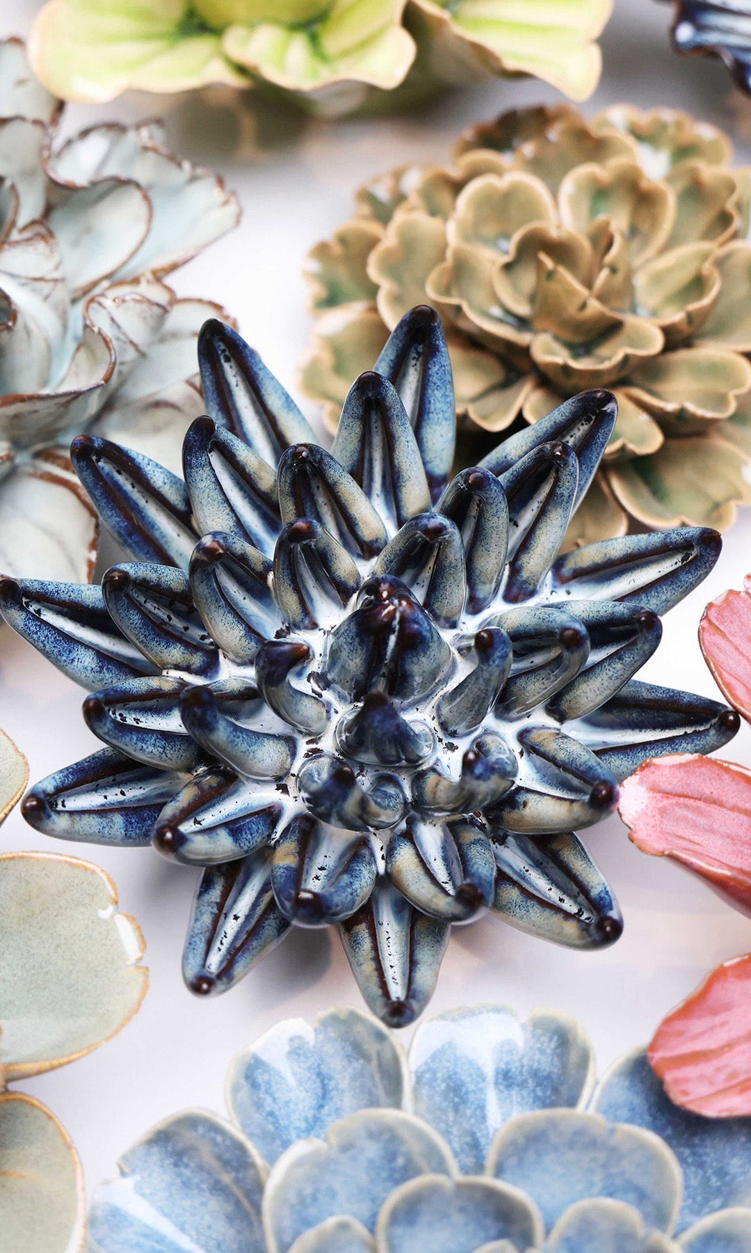 Navy Blue Succulent ceramic wall flower styled on a white table with other flowers — Chive Studio