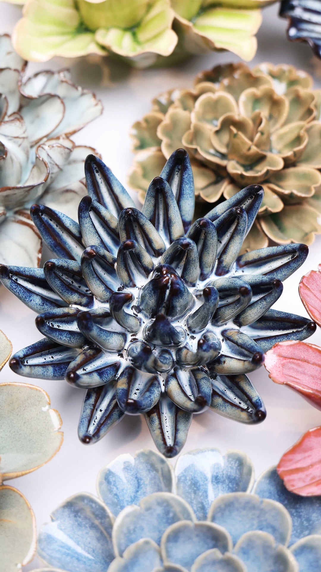 Navy Blue Succulent ceramic wall flower styled on a white table with other flowers — Chive Studio
