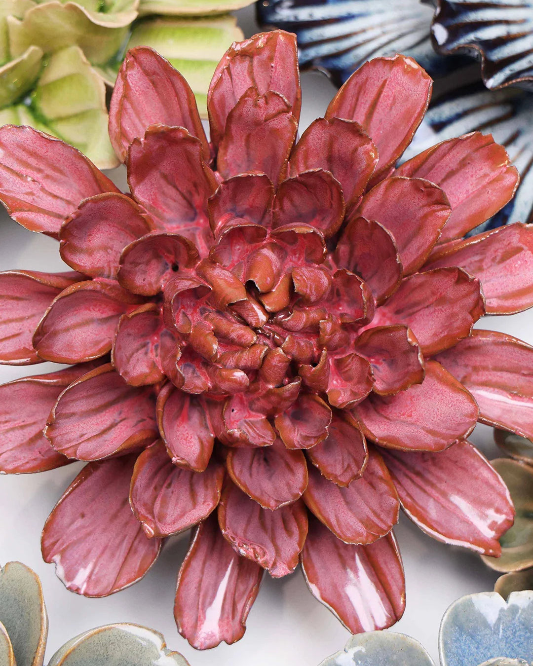Blush Pink Star Dahlia ceramic wall flower styled on a white table with other flowers — Chive Studio