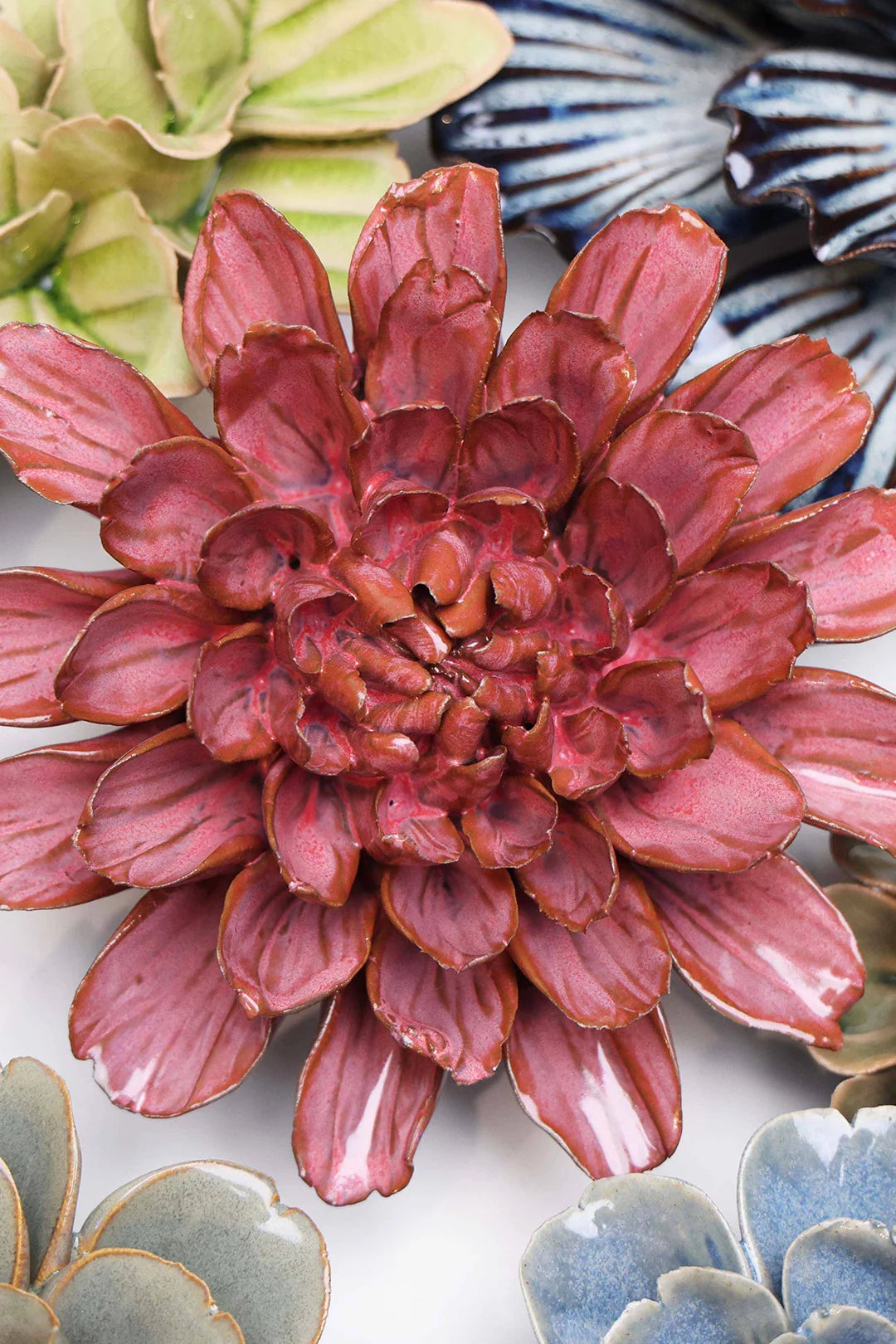 Blush Pink Star Dahlia ceramic wall flower styled on a white table with other flowers — Chive Studio