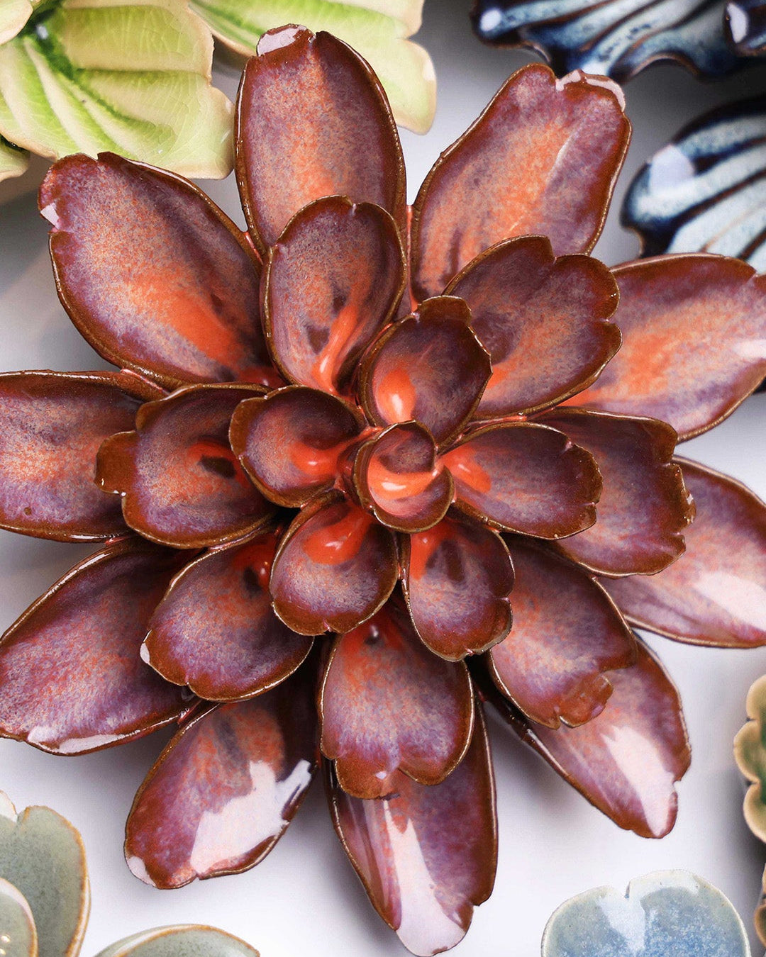 Peach Mocha Cornflower ceramic wall flower styled on a white table with other flowers — Chive Studio