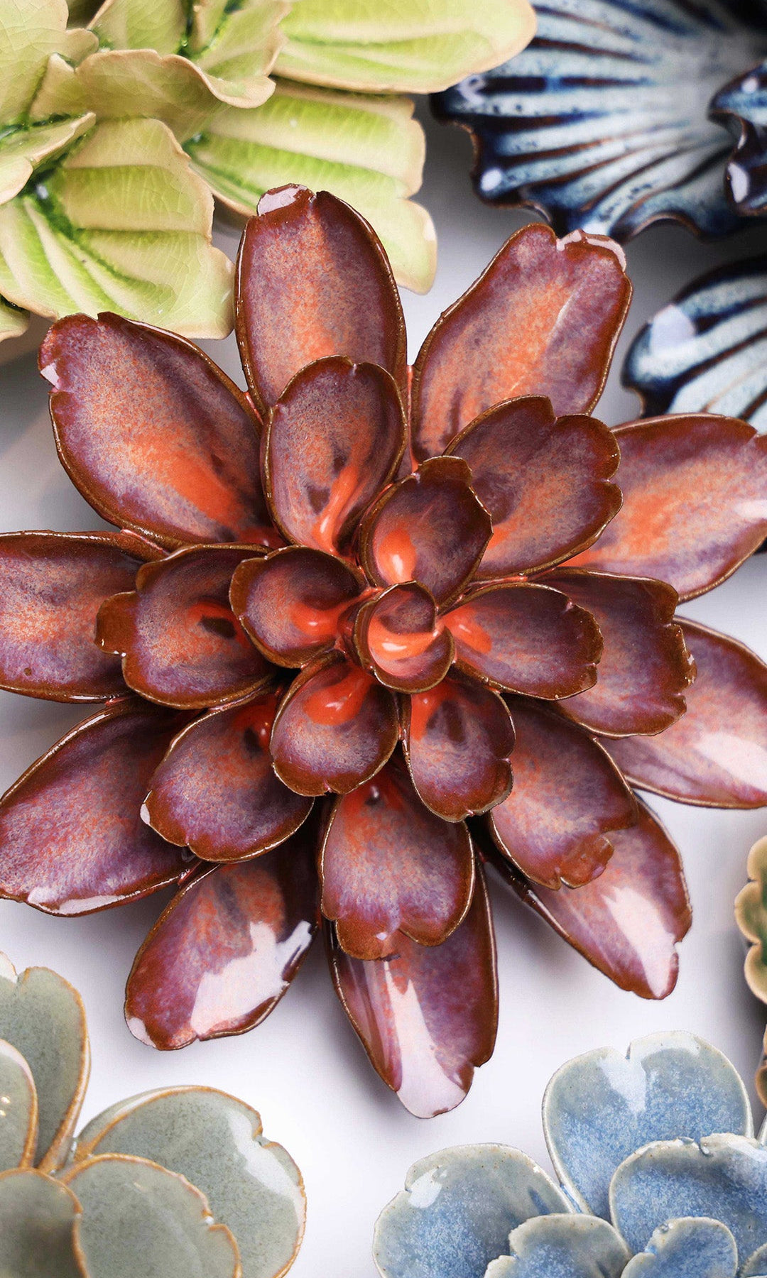 Peach Mocha Cornflower ceramic wall flower styled on a white table with other flowers — Chive Studio