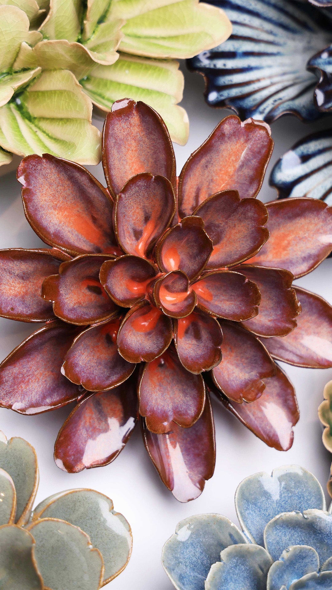 Peach Mocha Cornflower ceramic wall flower styled on a white table with other flowers — Chive Studio