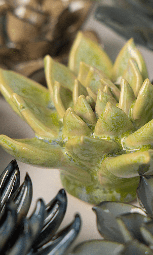 Pea Green Ghost Succulent ceramic wall flower styled on a white table with other flowers — Chive Studio