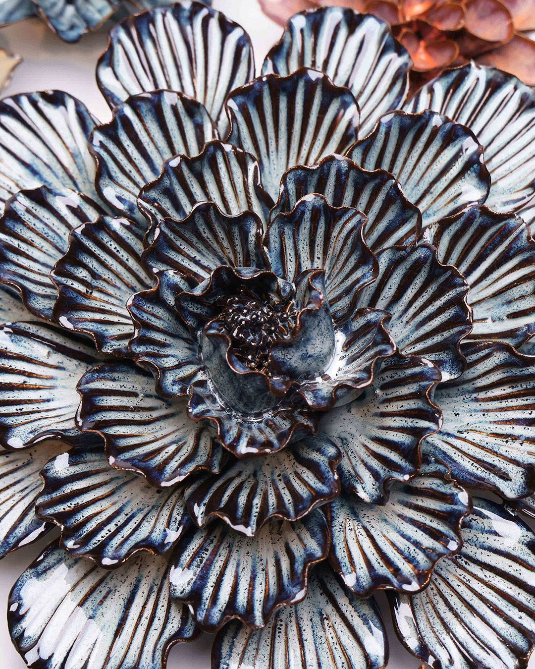 Navy Blue Dinner Plate Dahlia ceramic wall flower styled on a white table with other flowers — Chive Studio