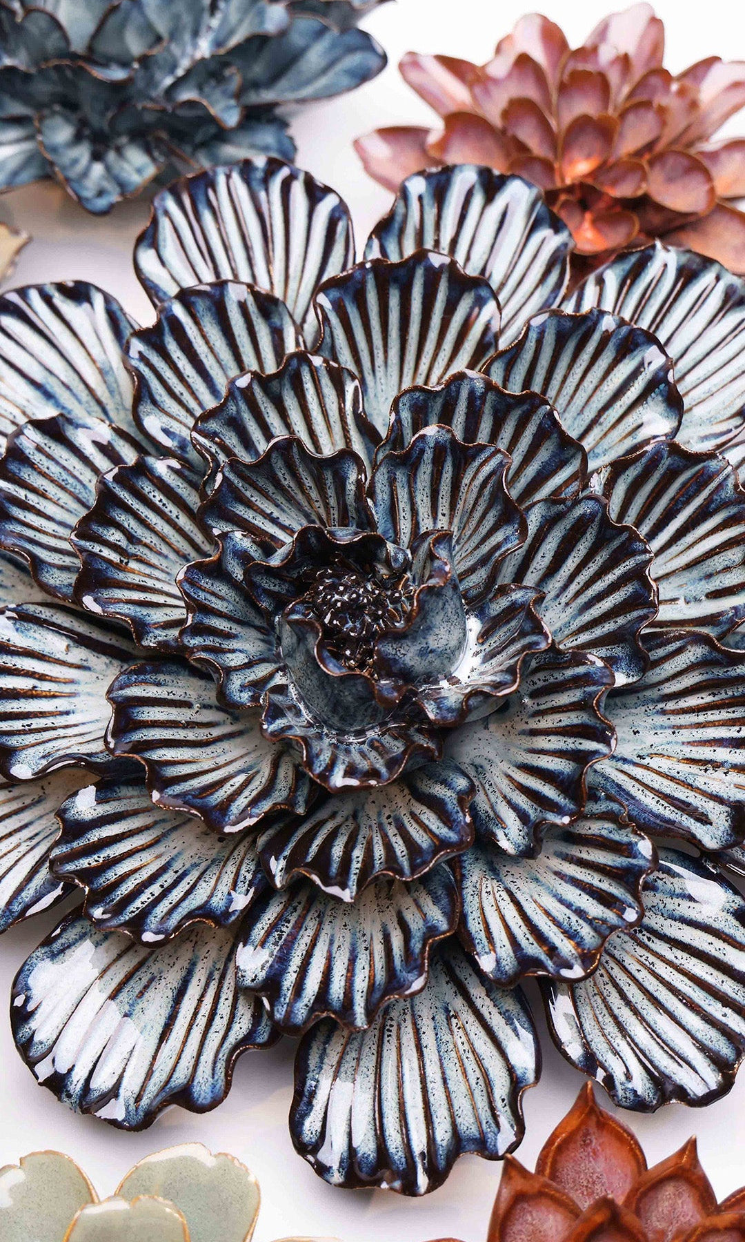 Navy Blue Dinner Plate Dahlia ceramic wall flower styled on a white table with other flowers — Chive Studio