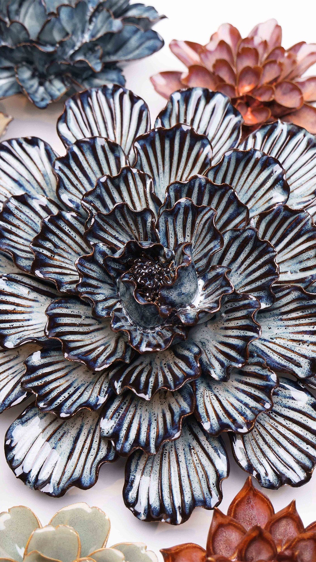 Navy Blue Dinner Plate Dahlia ceramic wall flower styled on a white table with other flowers — Chive Studio