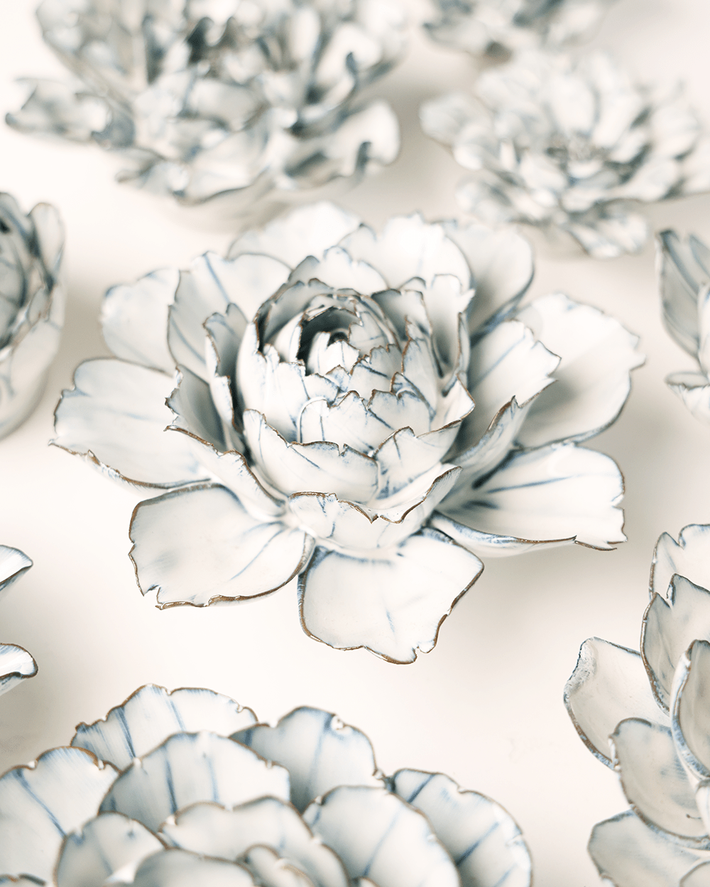 Blue White Camellia ceramic wall flower styled on wall — Coastal Collection — Chive Studio Toronto