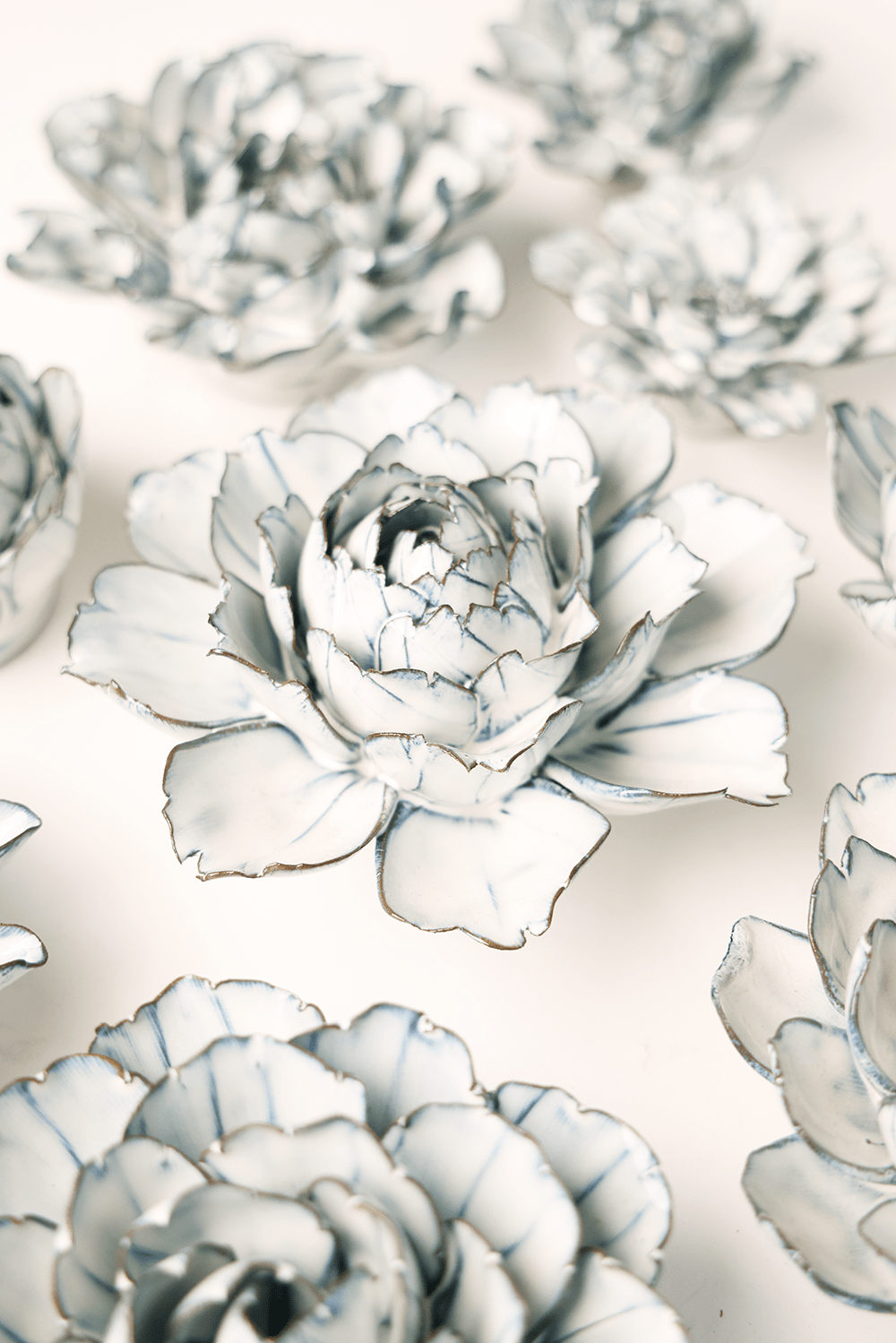 Blue White Camellia ceramic wall flower styled on wall — Coastal Collection — Chive Studio Toronto