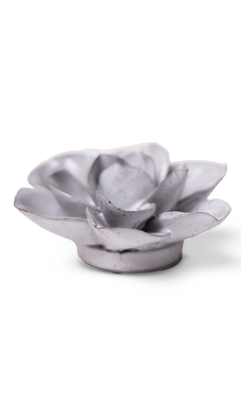 A small sculptural flower-shaped object in a matte light gray finish with subtle speckling, photographed on a clean white background.